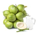 Glass jug of coconut water and young green coconut fruit cluster isolated on white background.