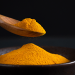 Firefly_A -spoon shot-—a wooden spoon lifting from a bowl of bright yellow turmeric Powder, s 480298