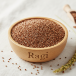 Firefly_Gemini Flash_A wooden bowl labelled as -Ragi- full of bright Finger - Red Millet (Ragi)_______, th 646571